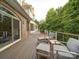 The beautiful wood deck features four chairs with foot rests and overlooks a lush backyard at 15708 Eagleview Dr, Charlotte, NC 28278