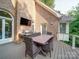 This wood deck features a brick wall, a grill, a large dining table, and plenty of room at 15708 Eagleview Dr, Charlotte, NC 28278