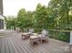 This deck has four chairs with foot rests and overlooks a lush backyard at 15708 Eagleview Dr, Charlotte, NC 28278
