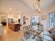 Open floorplan with kitchen view into dining area with glass table, velvet chairs, and patio access at 15708 Eagleview Dr, Charlotte, NC 28278
