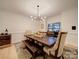 The dining room has a modern chandelier, ample seating, and a wine cooler at 15708 Eagleview Dr, Charlotte, NC 28278