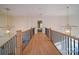 Second-floor hallway with modern chandeliers and natural light at 15708 Eagleview Dr, Charlotte, NC 28278