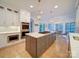 Eat-in kitchen features a spacious island, modern appliances, white cabinetry, and great lighting at 15708 Eagleview Dr, Charlotte, NC 28278
