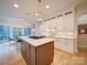 Modern kitchen with a large island, stainless steel appliances, white cabinets, and hardwood floors at 15708 Eagleview Dr, Charlotte, NC 28278