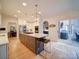 Bright kitchen boasts large island, stainless appliances, and access to an outdoor patio at 15708 Eagleview Dr, Charlotte, NC 28278