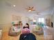 Spacious living area featuring multiple beanbag chairs, built-in shelving, and two ceiling fans at 15708 Eagleview Dr, Charlotte, NC 28278