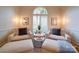 Bright sitting area with two armchairs, foot rests, and a large arched window at 15708 Eagleview Dr, Charlotte, NC 28278