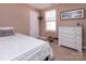 Bedroom with carpet flooring, a white bed frame, and a window with natural light at 15907 Rose Glenn Ln, Davidson, NC 28036
