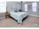 Bright bedroom featuring neutral walls, carpet flooring, and light-filled windows at 15907 Rose Glenn Ln, Davidson, NC 28036