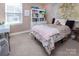 Bedroom featuring a large window, neutral carpet, and decoratively styled furniture at 15907 Rose Glenn Ln, Davidson, NC 28036
