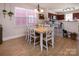 Bright dining area featuring a wooden table, white chairs, and natural light, creating a warm and inviting atmosphere at 15907 Rose Glenn Ln, Davidson, NC 28036