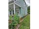 This home features a welcoming front porch, complete with comfortable seating area and flowering landscape at 15907 Rose Glenn Ln, Davidson, NC 28036