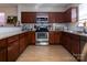 Well-equipped kitchen with stainless steel appliances, dark wood cabinetry, and plenty of counter space for cooking at 15907 Rose Glenn Ln, Davidson, NC 28036