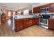 Kitchen with wood cabinets, stainless steel appliances, and an open view to the living area at 15907 Rose Glenn Ln, Davidson, NC 28036