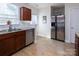 Bright kitchen with stainless steel appliances, wood cabinets, and wood-look vinyl flooring at 15907 Rose Glenn Ln, Davidson, NC 28036