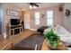 Bright living room featuring a cozy sectional sofa, wood-look flooring, and natural light, creating an inviting space at 15907 Rose Glenn Ln, Davidson, NC 28036