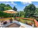 Backyard with a wooden deck, outdoor seating, mature trees, and lush landscaping at 167 Foxtail Dr, Mooresville, NC 28117