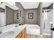Bathroom with soaking tub, shower, and double sink vanity at 167 Foxtail Dr, Mooresville, NC 28117
