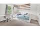 Bright bedroom featuring a built-in bed with drawers, a white desk, and decorative wooden shelving at 167 Foxtail Dr, Mooresville, NC 28117
