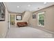 Spacious bonus room with a comfortable leather couch and a bright window for natural light at 167 Foxtail Dr, Mooresville, NC 28117