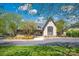 Attractive community building with stone accents, a well-maintained lawn, and blue sky at 167 Foxtail Dr, Mooresville, NC 28117