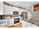Well-equipped kitchen with white cabinets, stainless steel appliances, and island at 167 Foxtail Dr, Mooresville, NC 28117