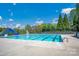 Community pool with a slide for and a seating area for relaxing on a bright, sunny day at 167 Foxtail Dr, Mooresville, NC 28117