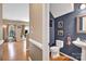 Charming powder room with blue accent wall, pedestal sink, and wood flooring at 167 Foxtail Dr, Mooresville, NC 28117
