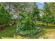 Beautiful yard featuring lush greenery, landscaping, and a charming sign with an arrow at 167 Foxtail Dr, Mooresville, NC 28117