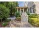 Charming backyard with stone path leading to the screened-in porch, and lush landscaping at 1701 Truman Rd, Charlotte, NC 28205