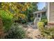 Charming backyard featuring lush landscaping, a stone path, and a screened-in porch at 1701 Truman Rd, Charlotte, NC 28205
