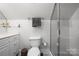 Bright bathroom featuring a glass enclosed shower and a vanity sink at 1701 Truman Rd, Charlotte, NC 28205