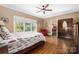 Bedroom with hardwood floors, ceiling fan, and ample natural light at 1701 Truman Rd, Charlotte, NC 28205