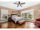 Bright bedroom with hardwood floors, ceiling fan, natural light, and neutral color scheme at 1701 Truman Rd, Charlotte, NC 28205