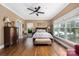 Bright bedroom with hardwood floors, ceiling fan, natural light, and neutral color scheme at 1701 Truman Rd, Charlotte, NC 28205