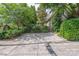 Long driveway leading to the home with lush landscaping for added privacy at 1701 Truman Rd, Charlotte, NC 28205