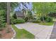 Charming home with lush landscaping, a spacious driveway and welcoming curb appeal at 1701 Truman Rd, Charlotte, NC 28205