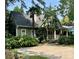 Charming exterior view of a home featuring lush landscaping, a front porch and a spacious driveway at 1701 Truman Rd, Charlotte, NC 28205