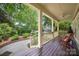 Charming covered front porch with wood flooring and comfortable rocking chairs, perfect for relaxing outdoors at 1701 Truman Rd, Charlotte, NC 28205