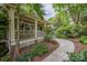 Inviting front porch with stone walkway, detailed trim work, and lush landscaping for serene outdoor living at 1701 Truman Rd, Charlotte, NC 28205