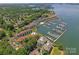 Aerial view of a large waterfront community. Includes docks, boats, housing and tree filled landscapes at 18733 Bluff Point Rd, Cornelius, NC 28031