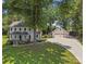 An aerial view showcasing the home, the detached garage and the long driveway on a well-maintained lawn at 18733 Bluff Point Rd, Cornelius, NC 28031