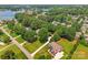 An aerial view of a large two-story home surrounded by lush landscaping and green lawn at 18733 Bluff Point Rd, Cornelius, NC 28031