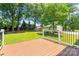View of a grassy backyard from a beautiful deck with mature trees and landscaping at 18733 Bluff Point Rd, Cornelius, NC 28031
