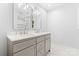 Modern bathroom with dual vanities, elegant mirrors, and bright lighting at 18733 Bluff Point Rd, Cornelius, NC 28031