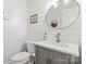 Stylish half bathroom featuring shiplap walls, a modern vanity, and a round mirror at 18733 Bluff Point Rd, Cornelius, NC 28031