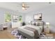 Staged bedroom featuring two windows and hardwood floors at 18733 Bluff Point Rd, Cornelius, NC 28031