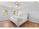 Serene bedroom with hardwood floors, ceiling fan, and double windows for natural light at 18733 Bluff Point Rd, Cornelius, NC 28031