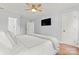 Bright bedroom featuring a comfortable bed, ceiling fan, and ample closet space at 18733 Bluff Point Rd, Cornelius, NC 28031