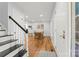 Welcoming foyer with hardwood floors, staircase, and ample natural light at 18733 Bluff Point Rd, Cornelius, NC 28031